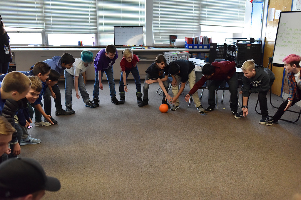 students playing with ball in classroom