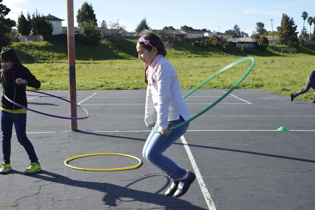 student playing with hula hoop